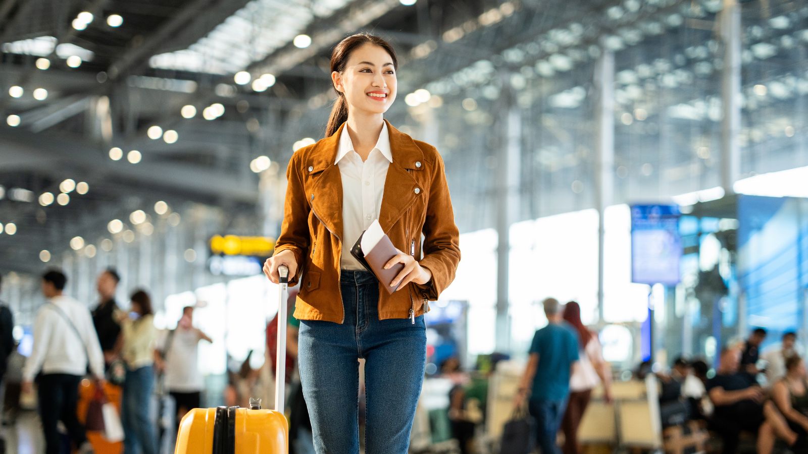 A photo of a Traveler arriving at destination refreshed and smiling, small suitcase in hand.