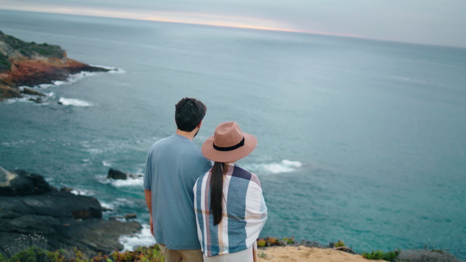 A back photo of a couple enjoying the view.