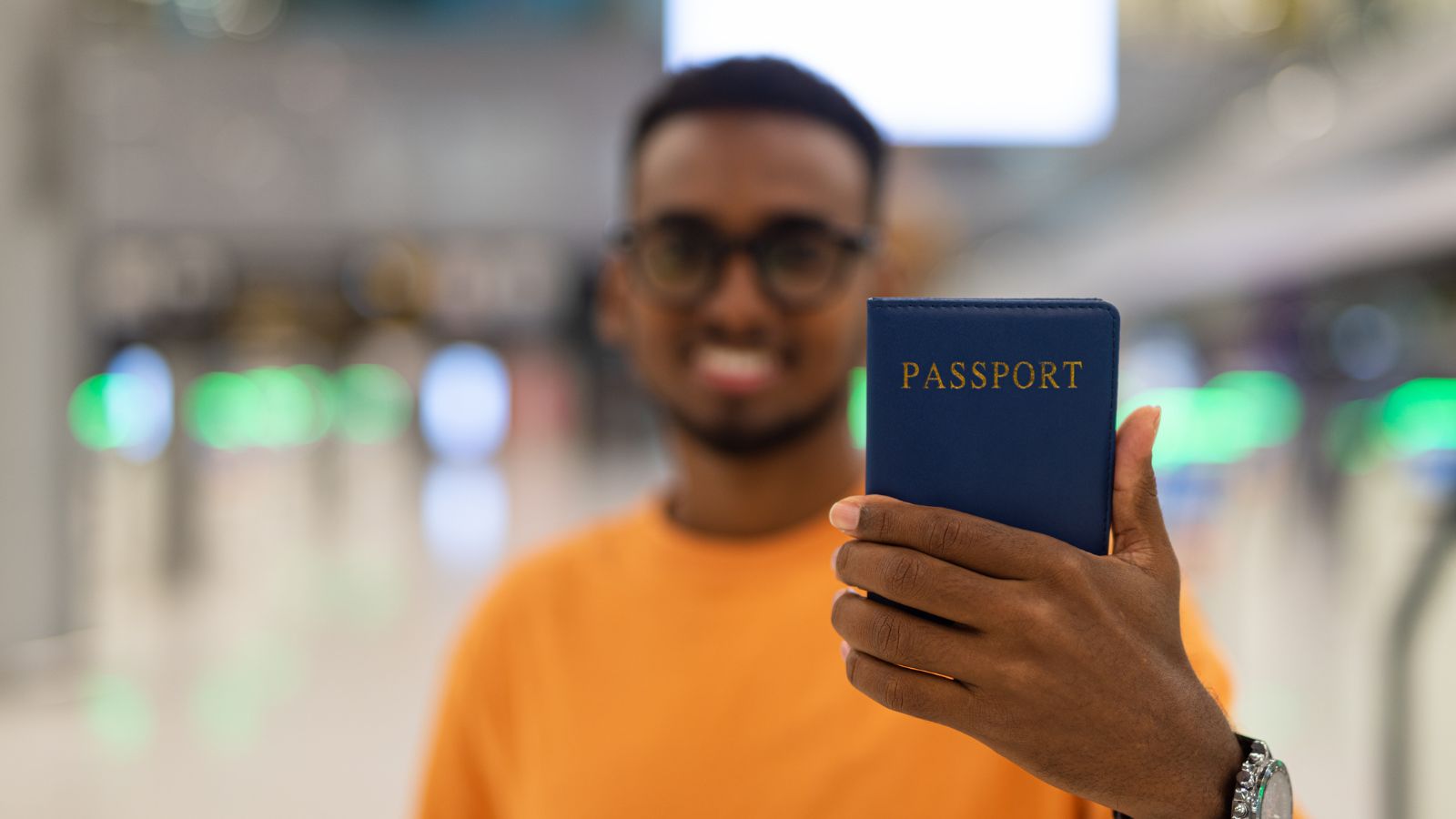 A photo of a man, showcasing his passport.