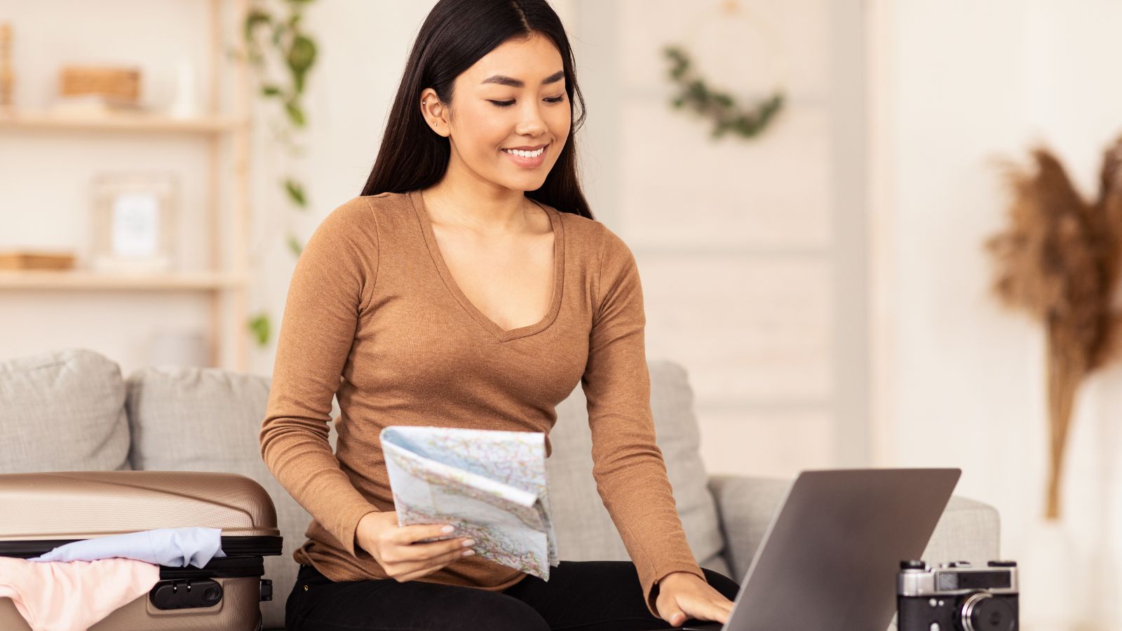 A photo that shows Confident traveler booking flight laptop.