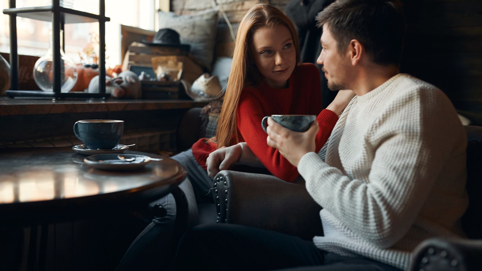 A photo of a Couple quiet café conversation.