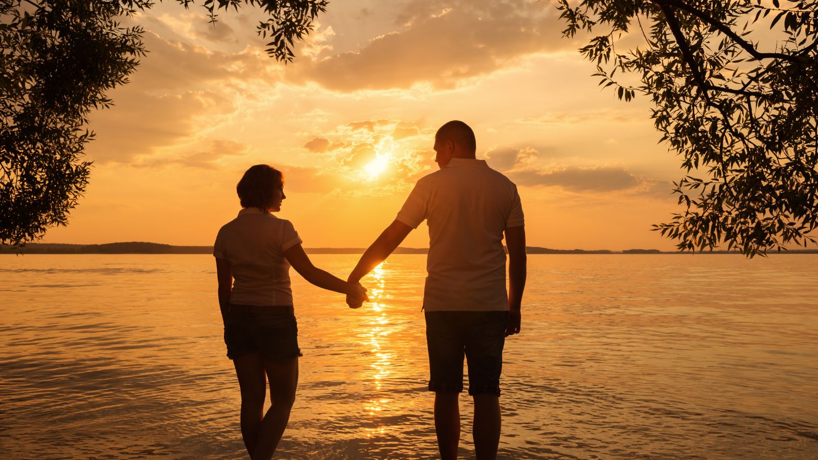 A photo of a Couple peaceful sunset walk.
