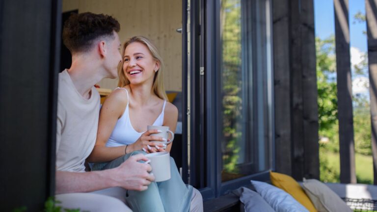 A photo that shows a loving couple cuddling at the balcony.
