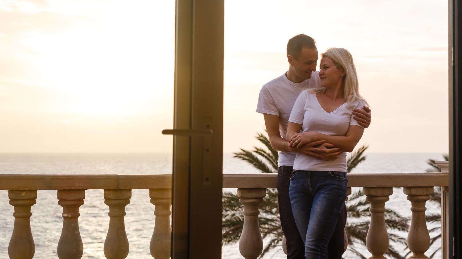 A photo of a couple balcony ocean sunset.