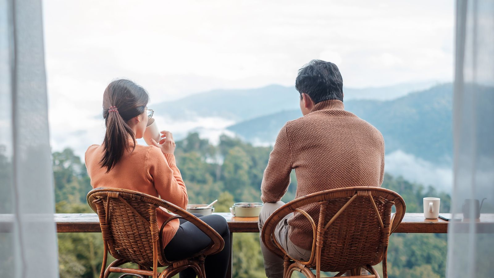 A photo of a couple balcony ocean sunset.