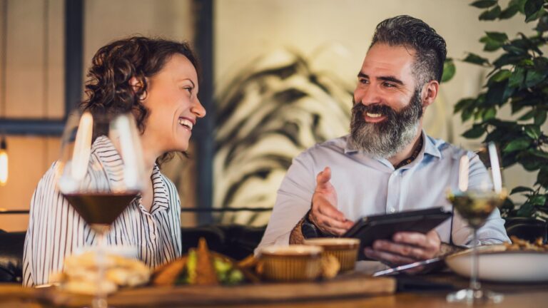 A photo of lovebirds sharing good time in a restaurant.