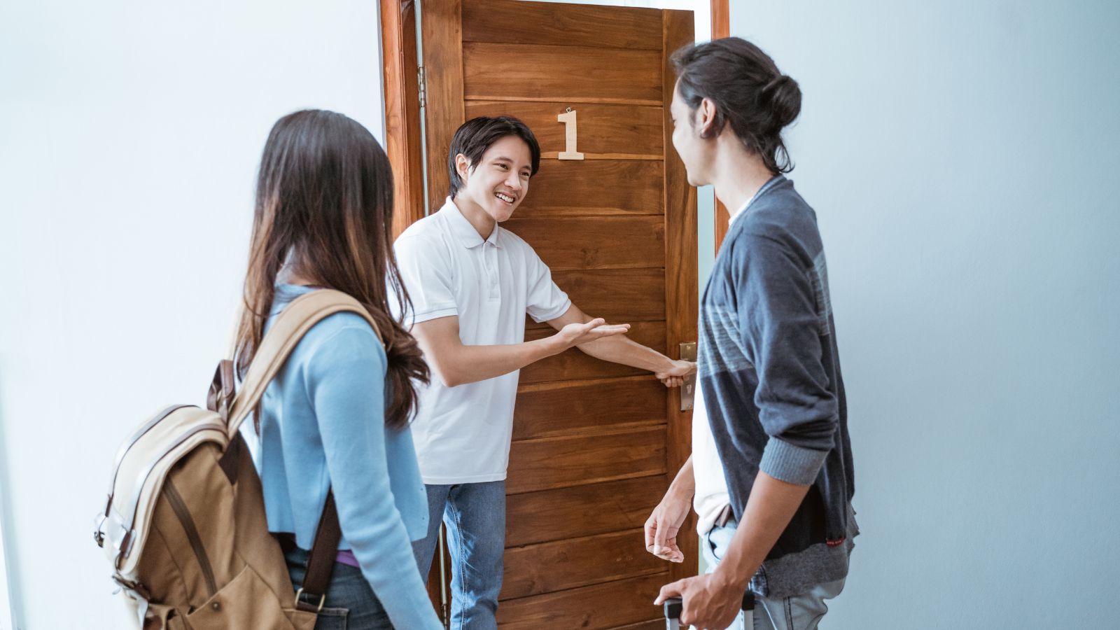 A photo of a Couple receiving hotel welcome.