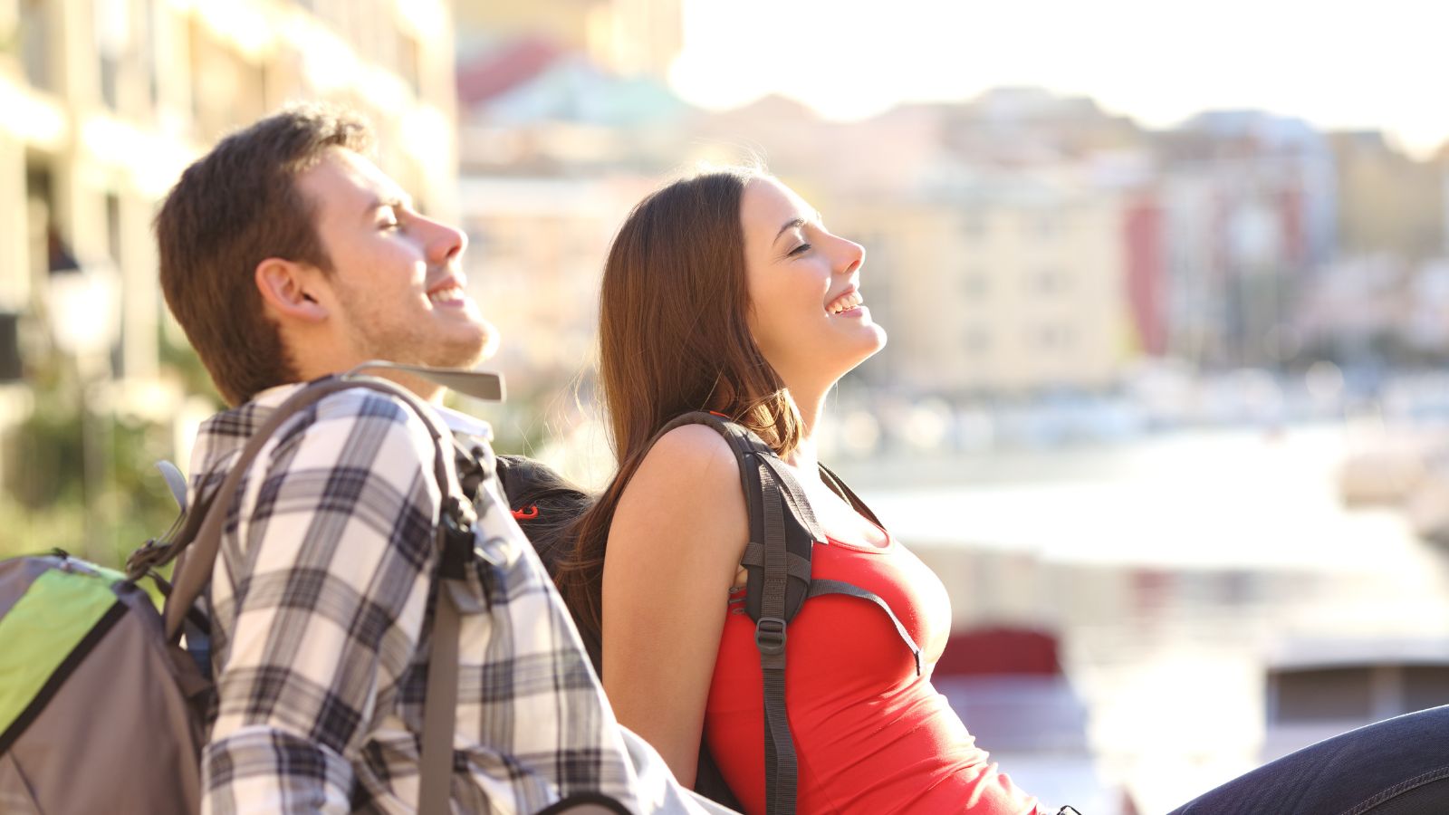 A photo of a Couple resting on a park bench.