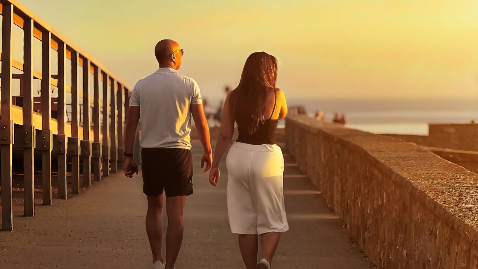 A photo of Couple relaxed sunset stroll.