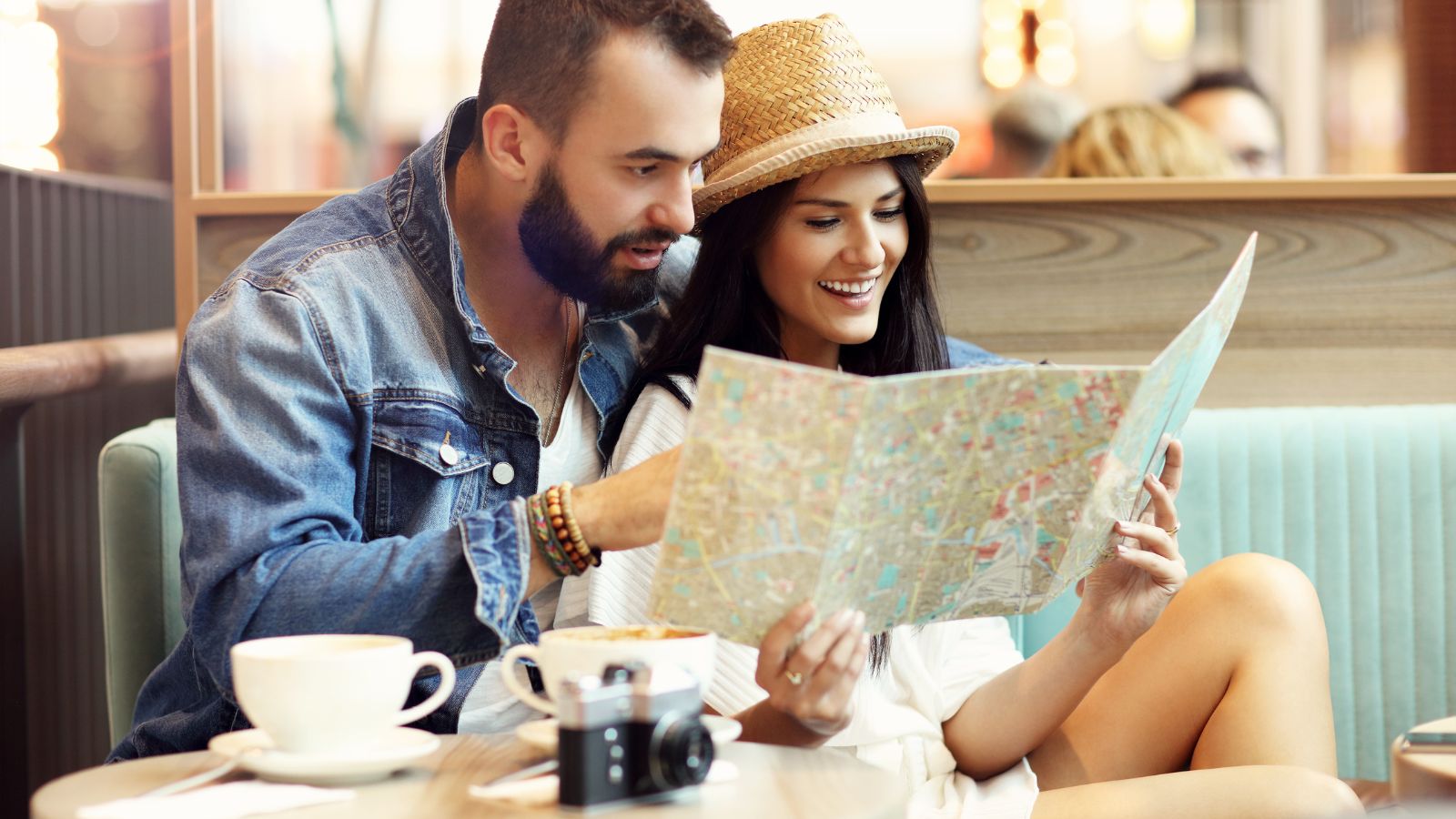 A photo of a couple sweetly looking at map together.