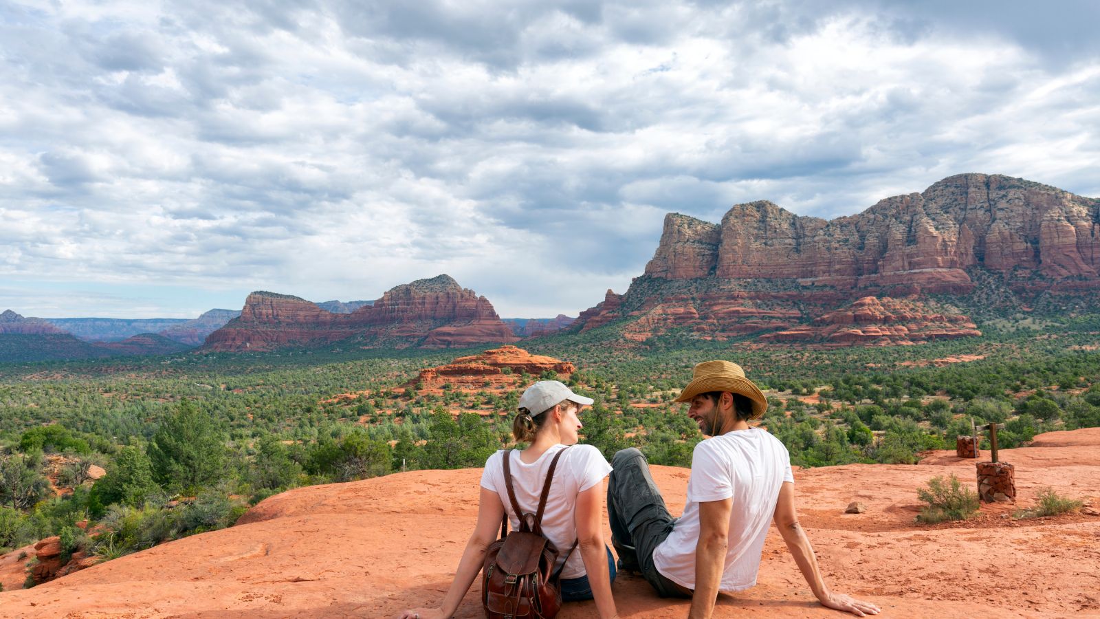 A photo of a Couple hiking along a quiet red rock trail in Sedona.