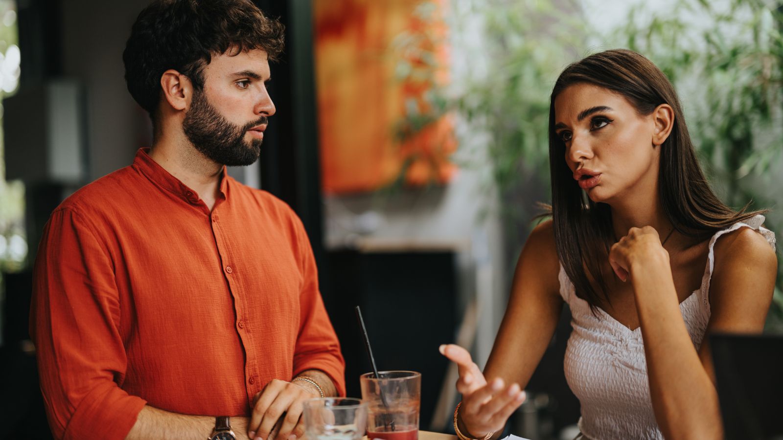 A photo that shows a Couple discussing restaurant decision.