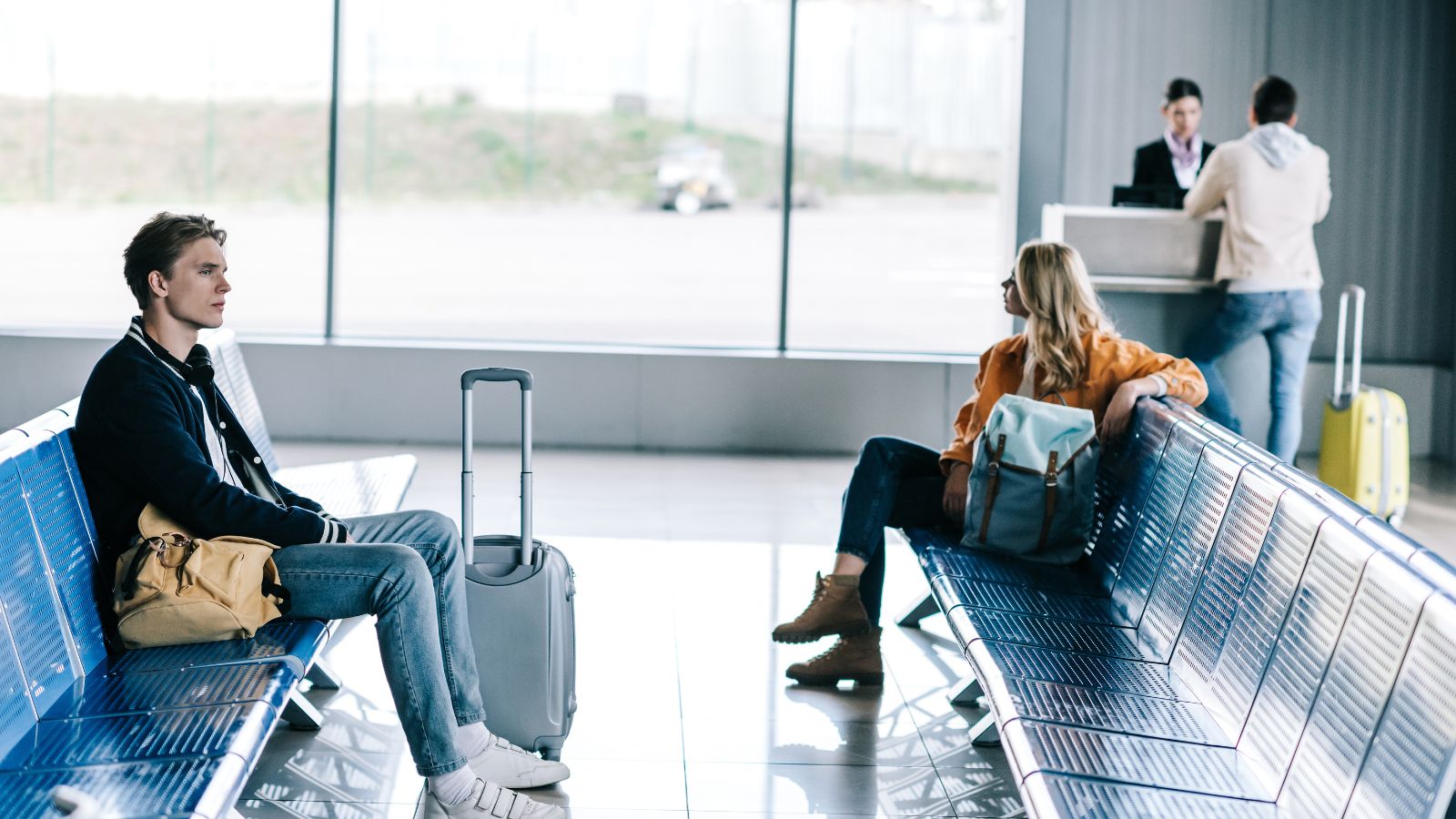 A photo of Couple tired airport waiting.