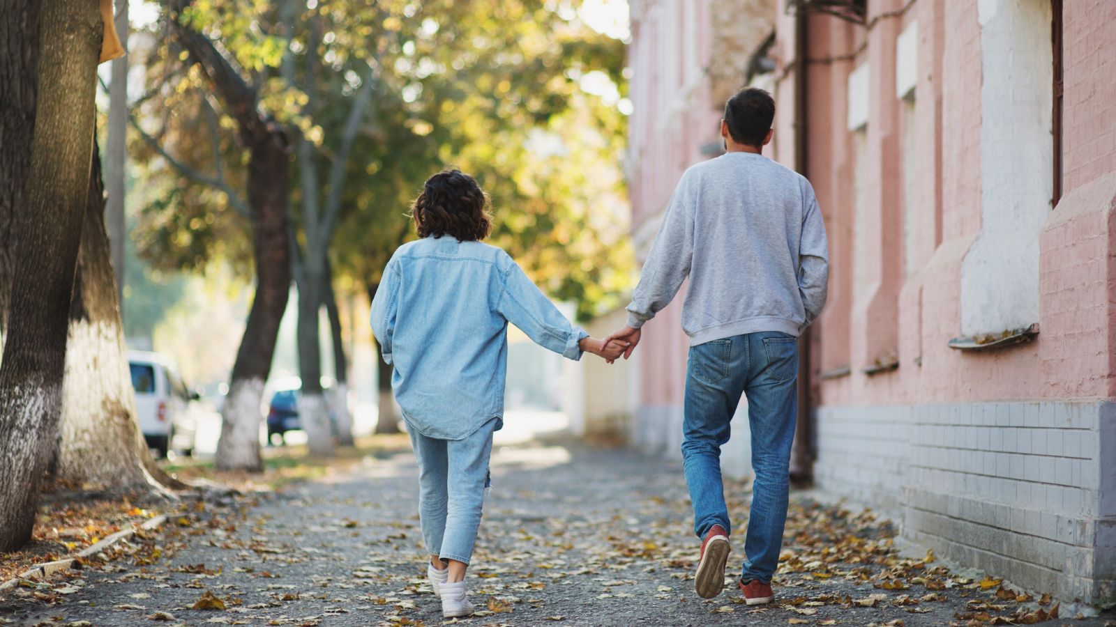 A photo of Couple walking quiet street.