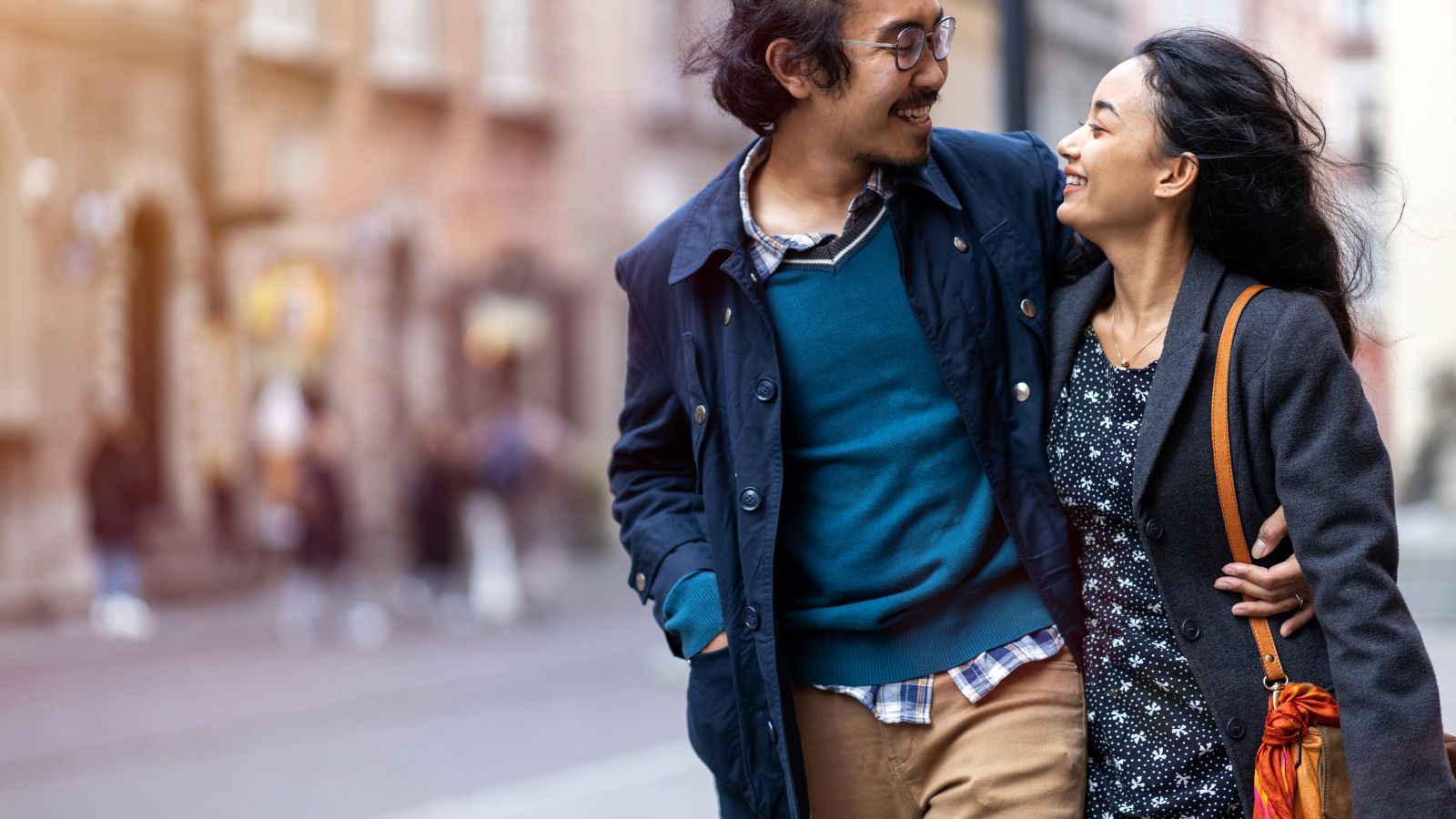 A photo of a Couple walking city street.