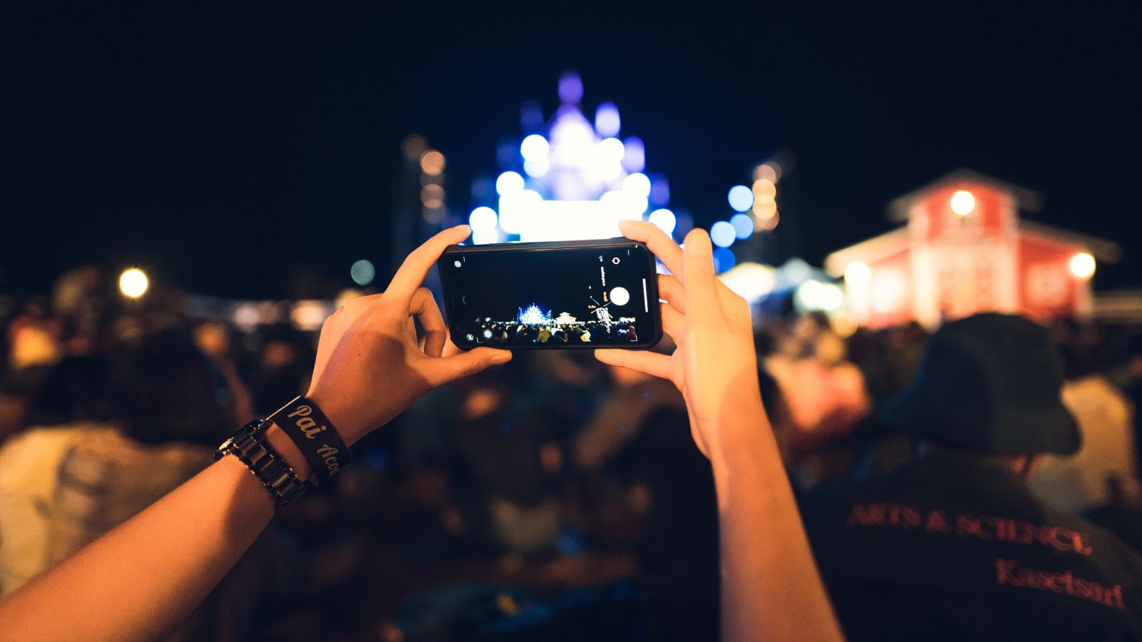 A photo of a hand capturing something in the crowd.