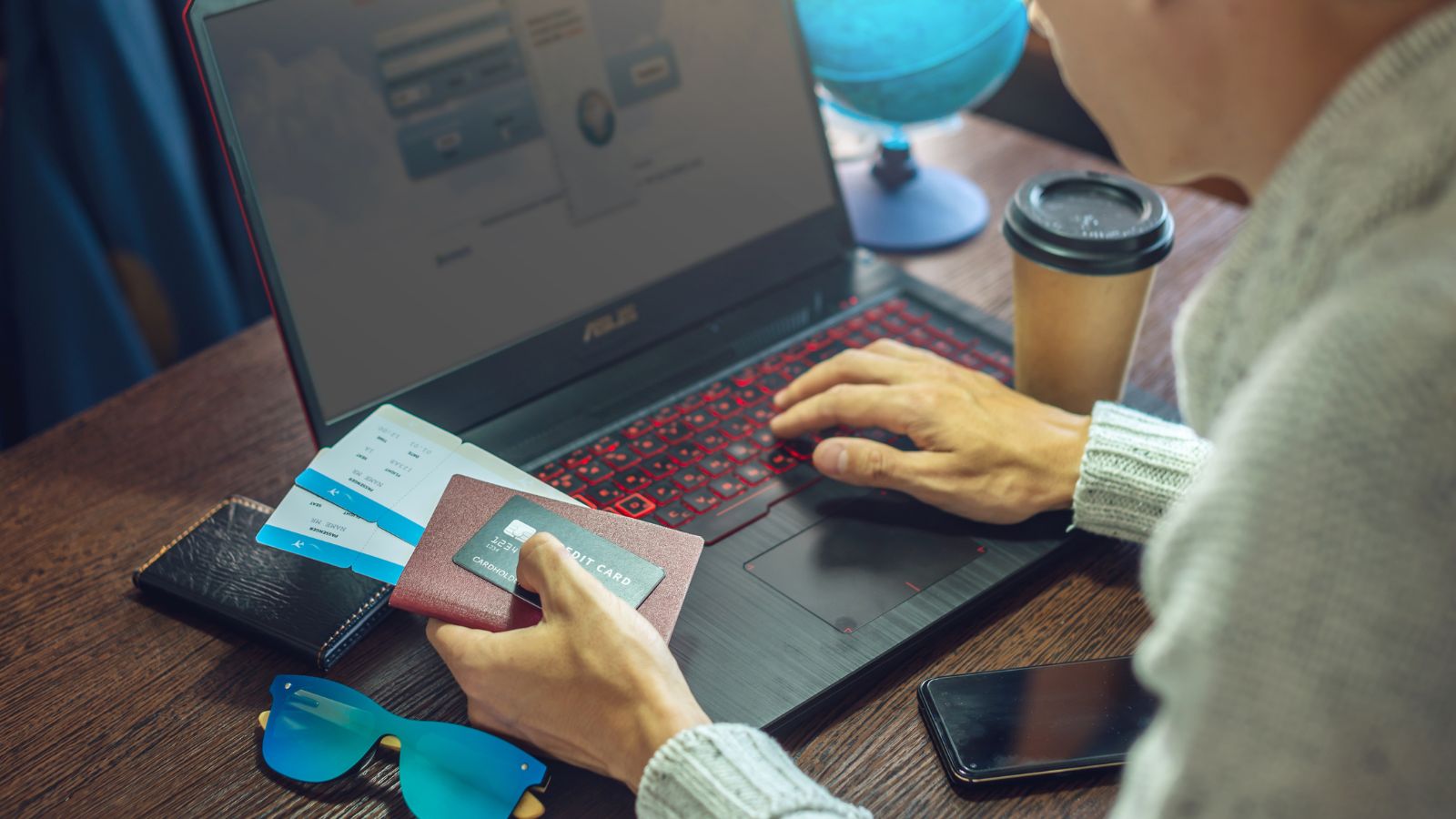 A photo of a man facing a laptop.