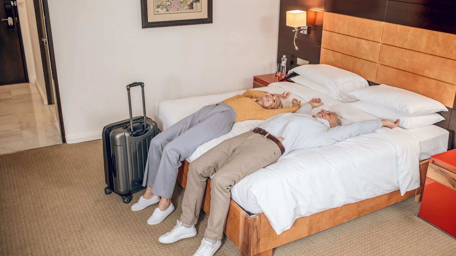 A photo of a Older travelers resting comfortably in a quiet hotel room after a day of sightseeing.