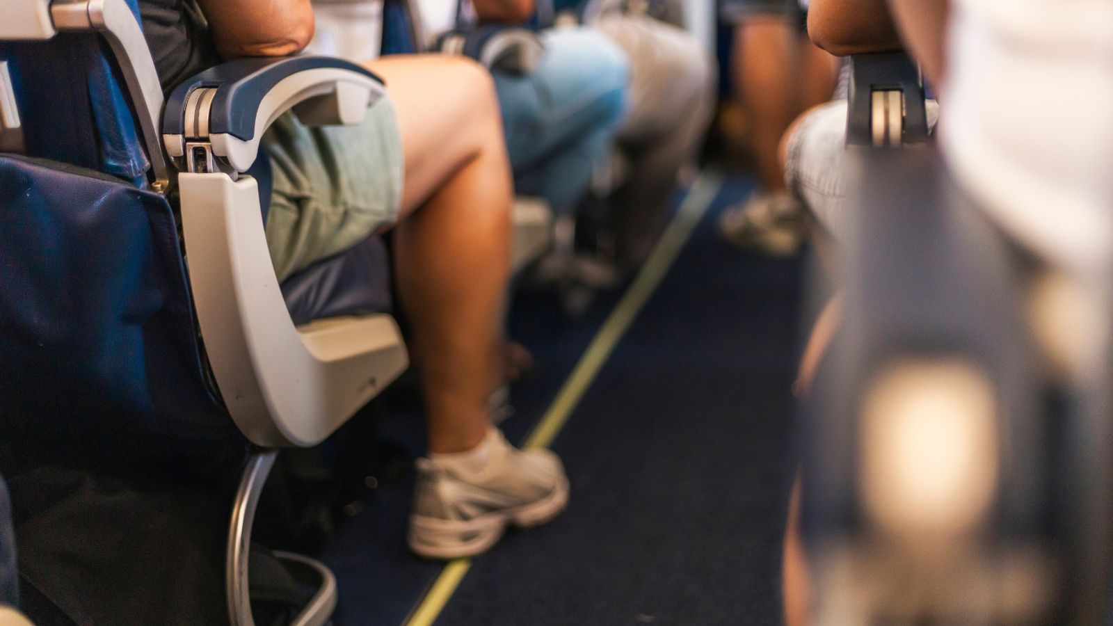 A photo of a Passenger cramped airplane economy seat.