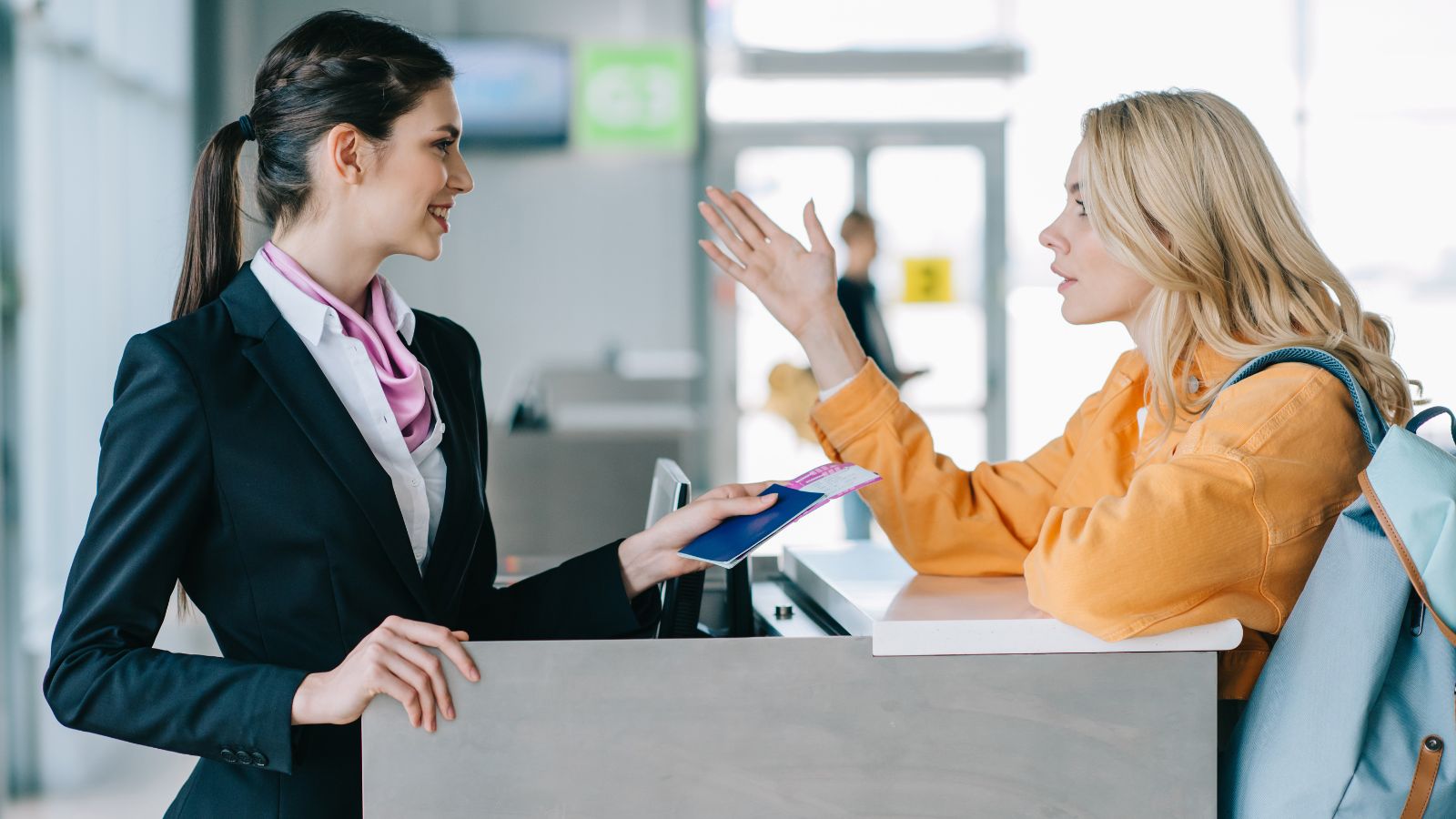 A photo of a Traveler speaking airline service counter.