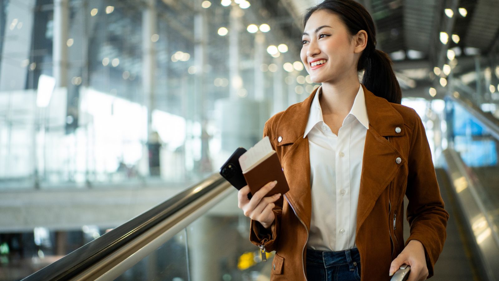 A photo of a Traveler walking away from immigration checkpoint with relaxed smile.