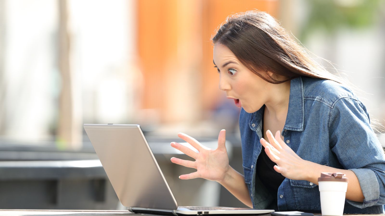 A photo of a Traveler shocked checking laptop.