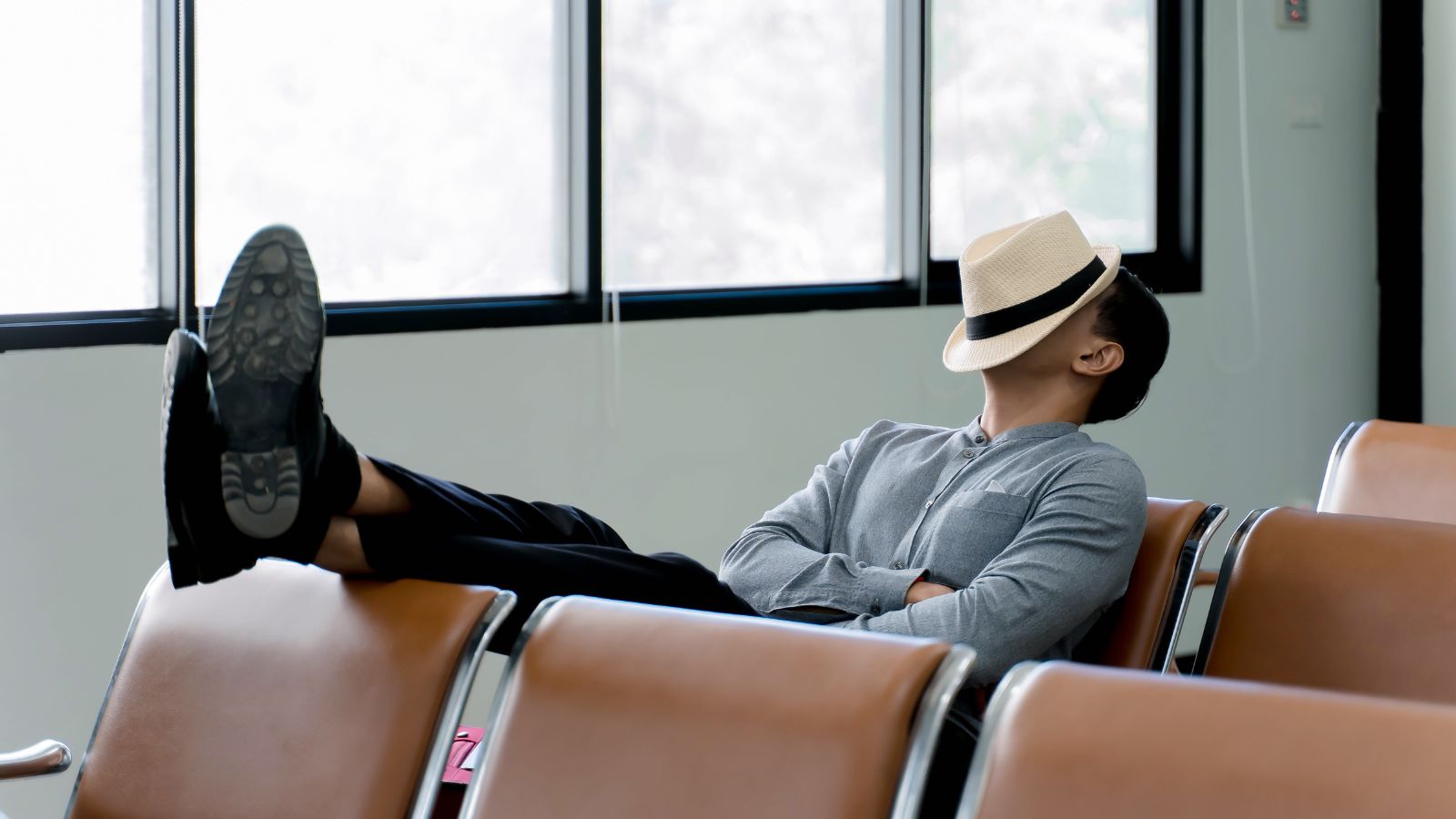 A photo of an Exhausted traveler, airport terminal.