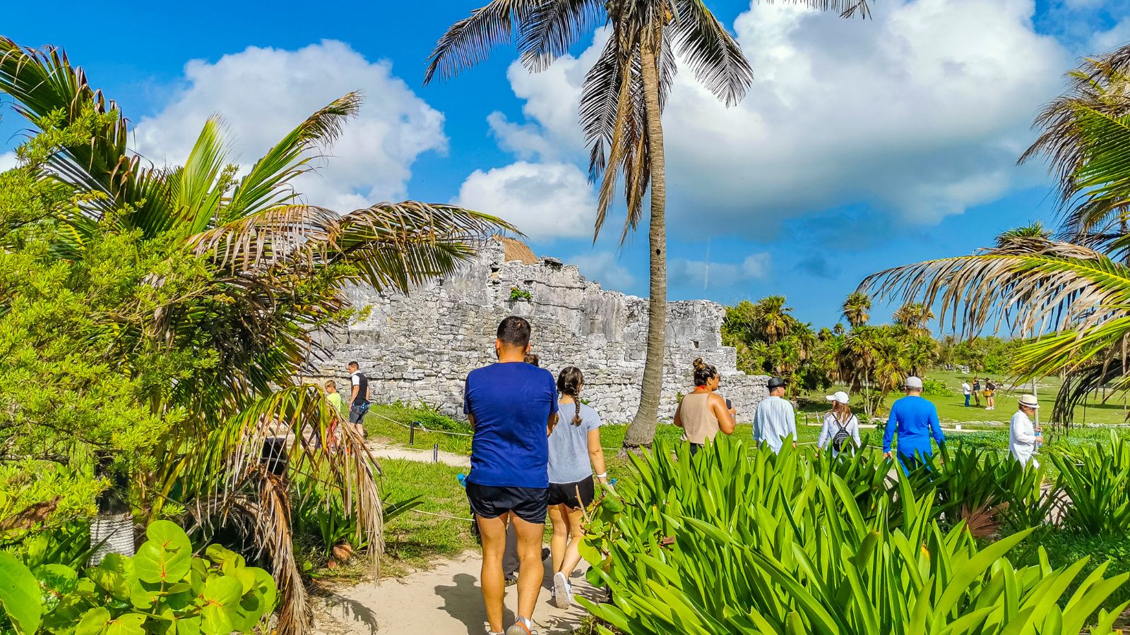 A photo of the Travelers exploring ancient Mayan ruins near the coast.
