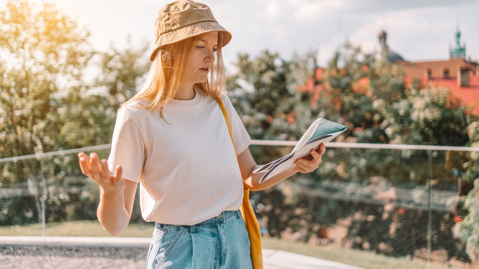 A photo of an Overwhelmed traveler reviewing city map.