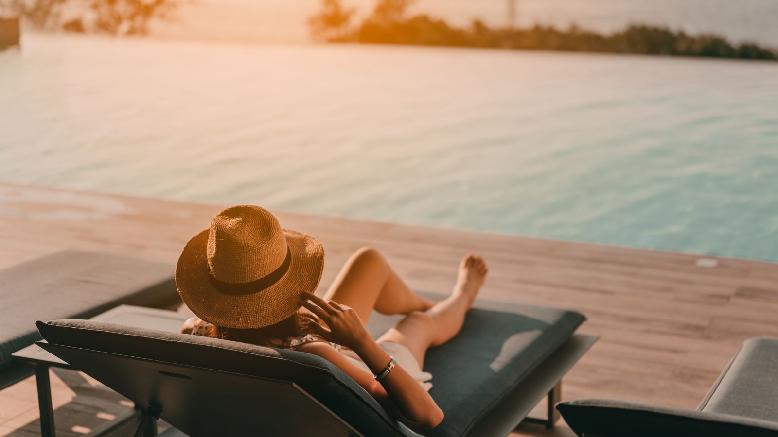 A photo of a Traveler relaxing poolside in Cabo with ocean view.