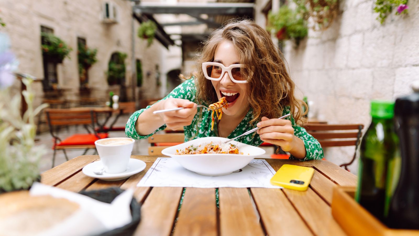A photo of a Traveler smiling in surprise after tasting food.