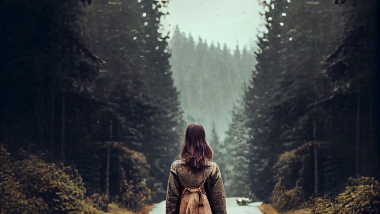 A photo of a woman facing a scenery.
