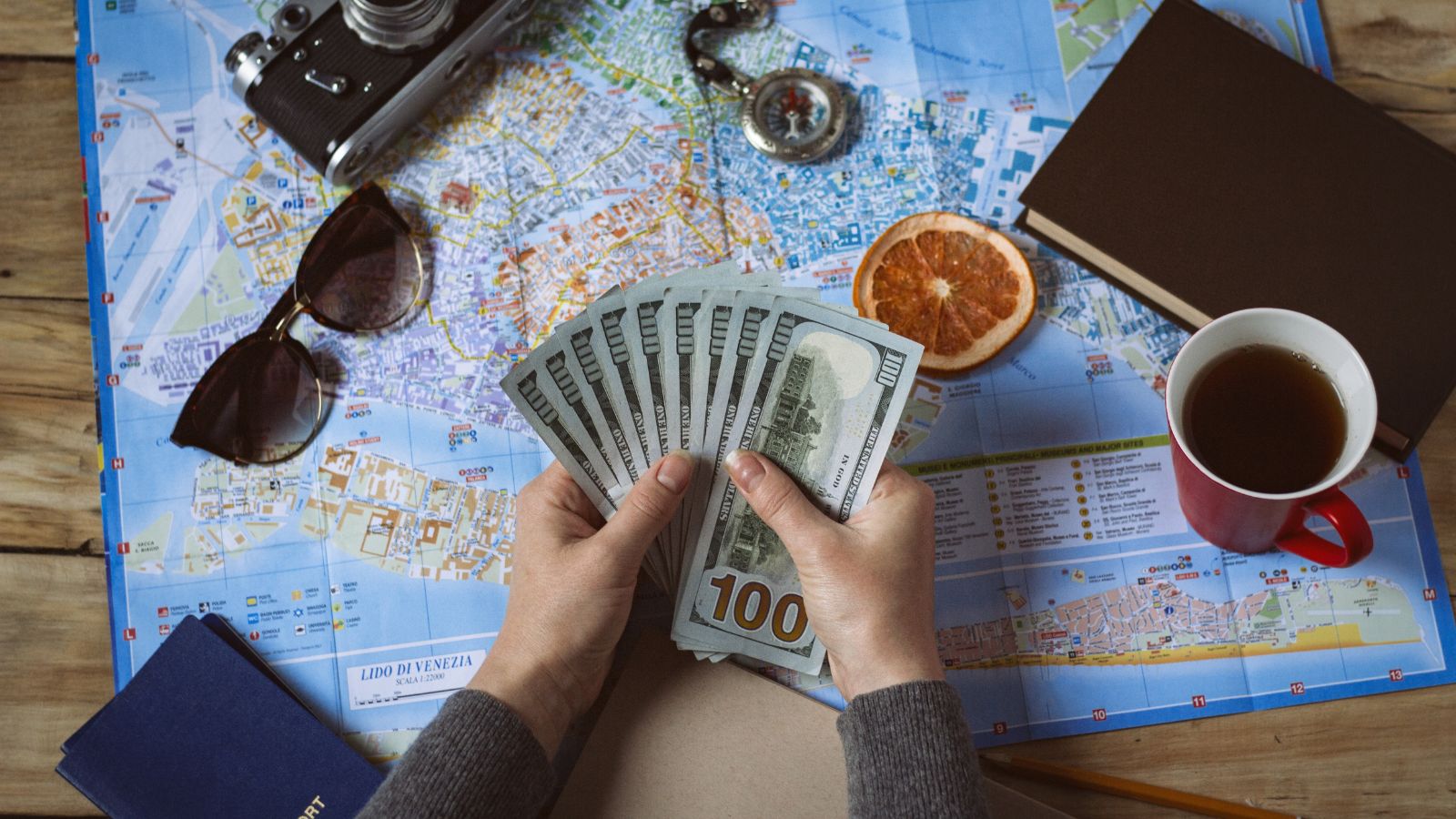 A photo that shows a hand of a woman holding cash.