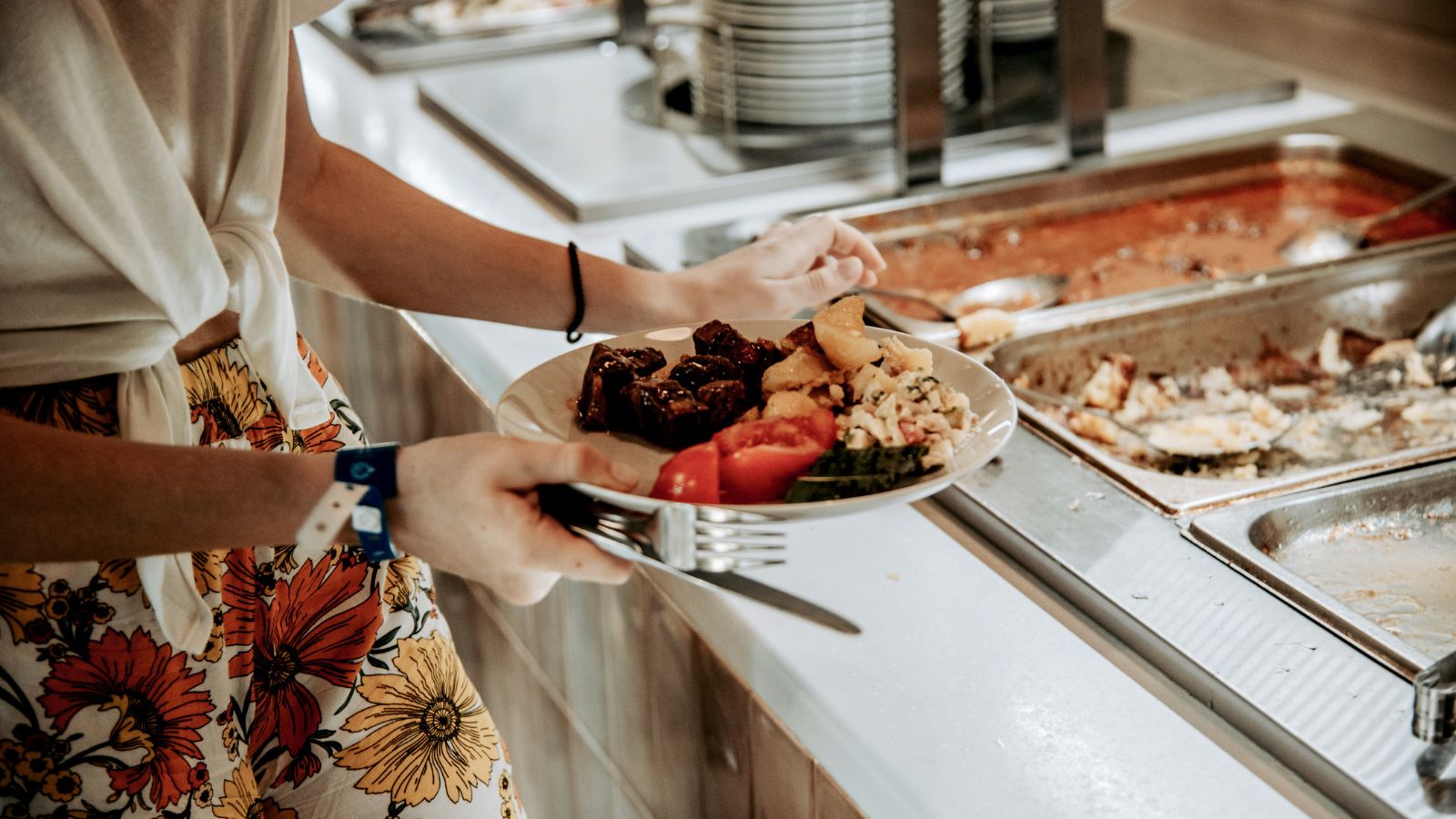 A photo of a Traveler enjoying a buffet or plated meal at a Cancun resort.