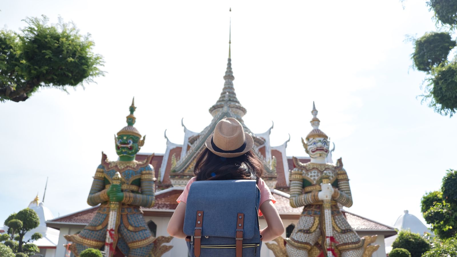 A photo of a traveler respectfully looking at the temple.