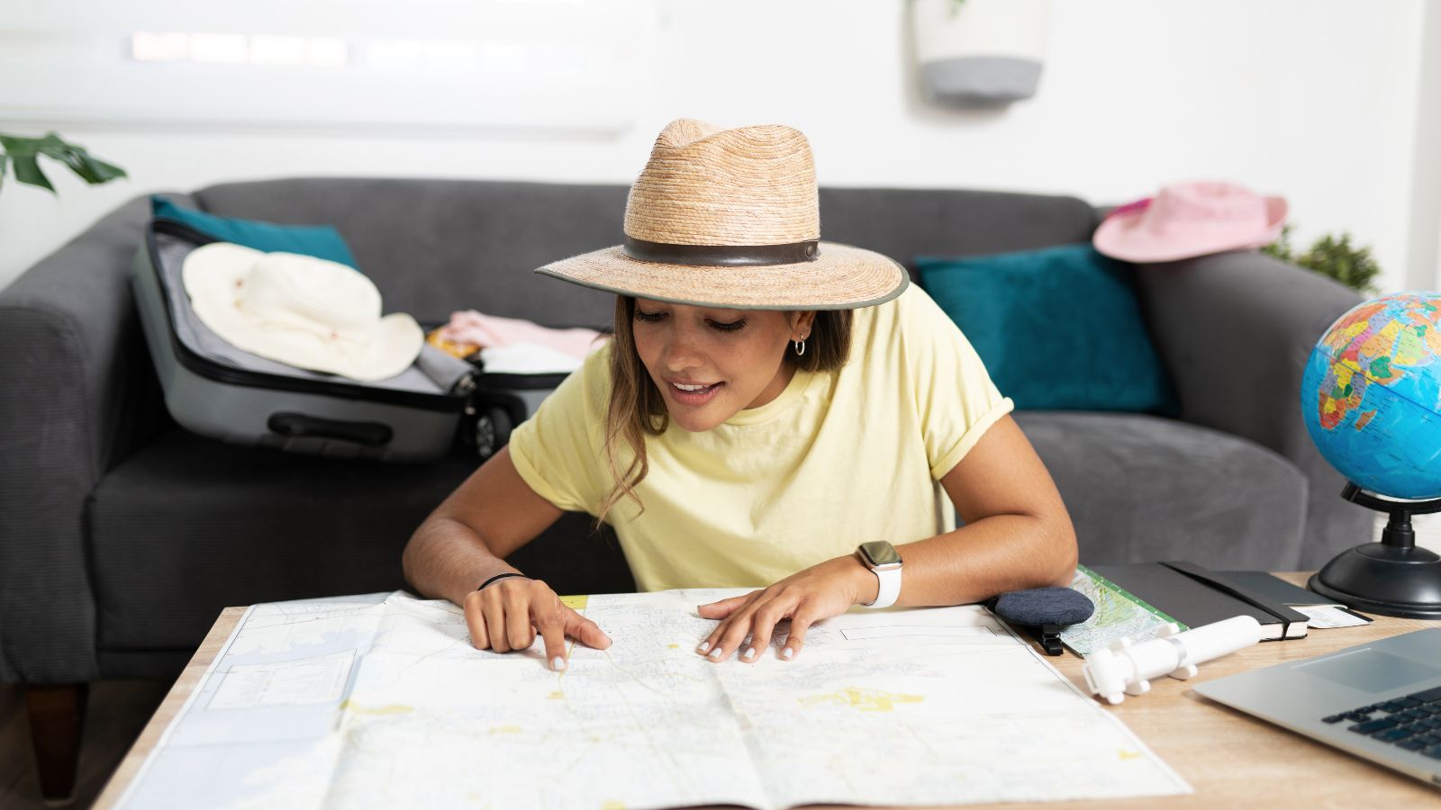 A photo that shows a woman planning for a trip happily.