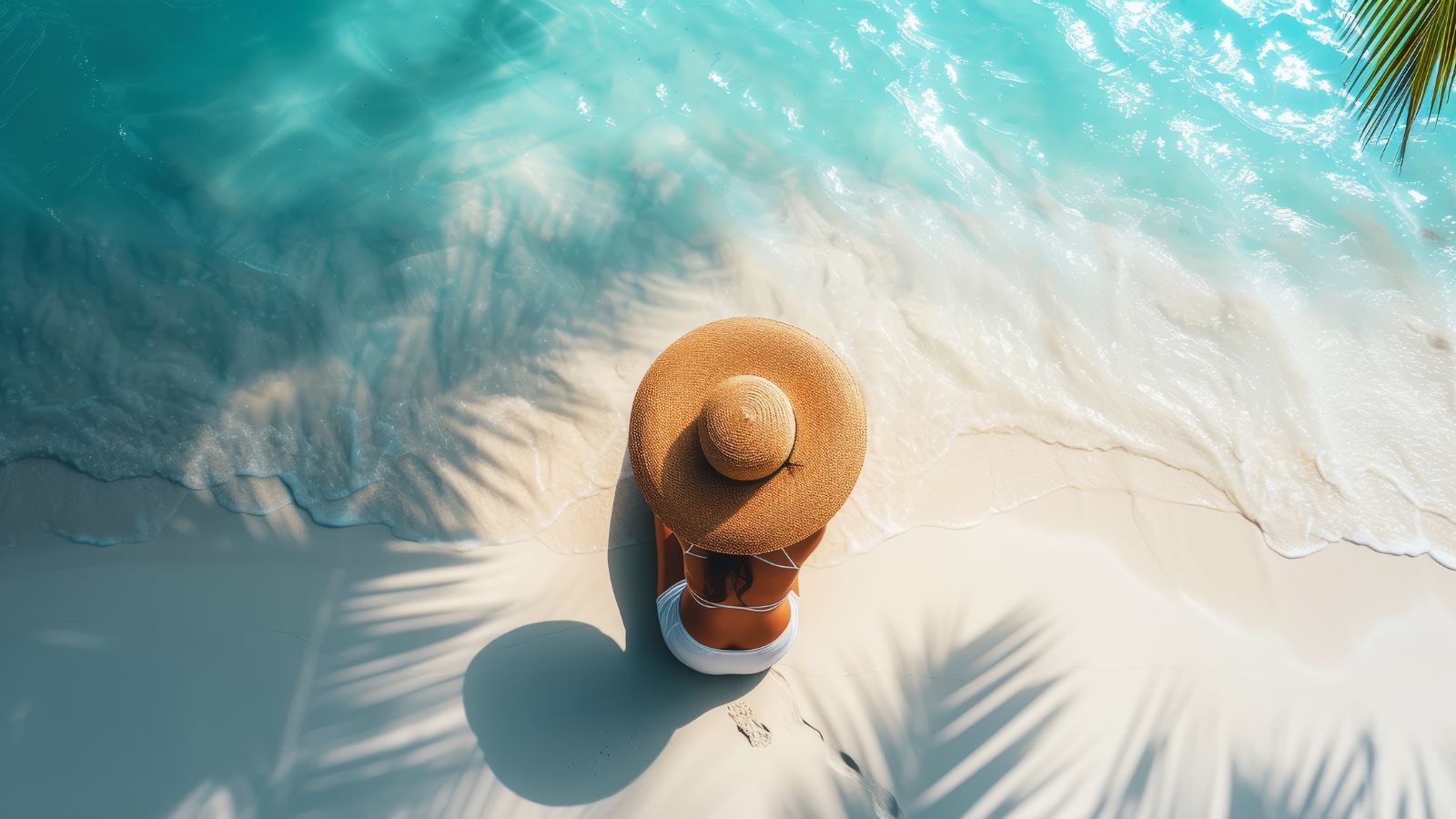 A photo of a Traveler enjoying a calm Cancun beach with turquoise water, palm trees, and distant nightlife visible but subdued.