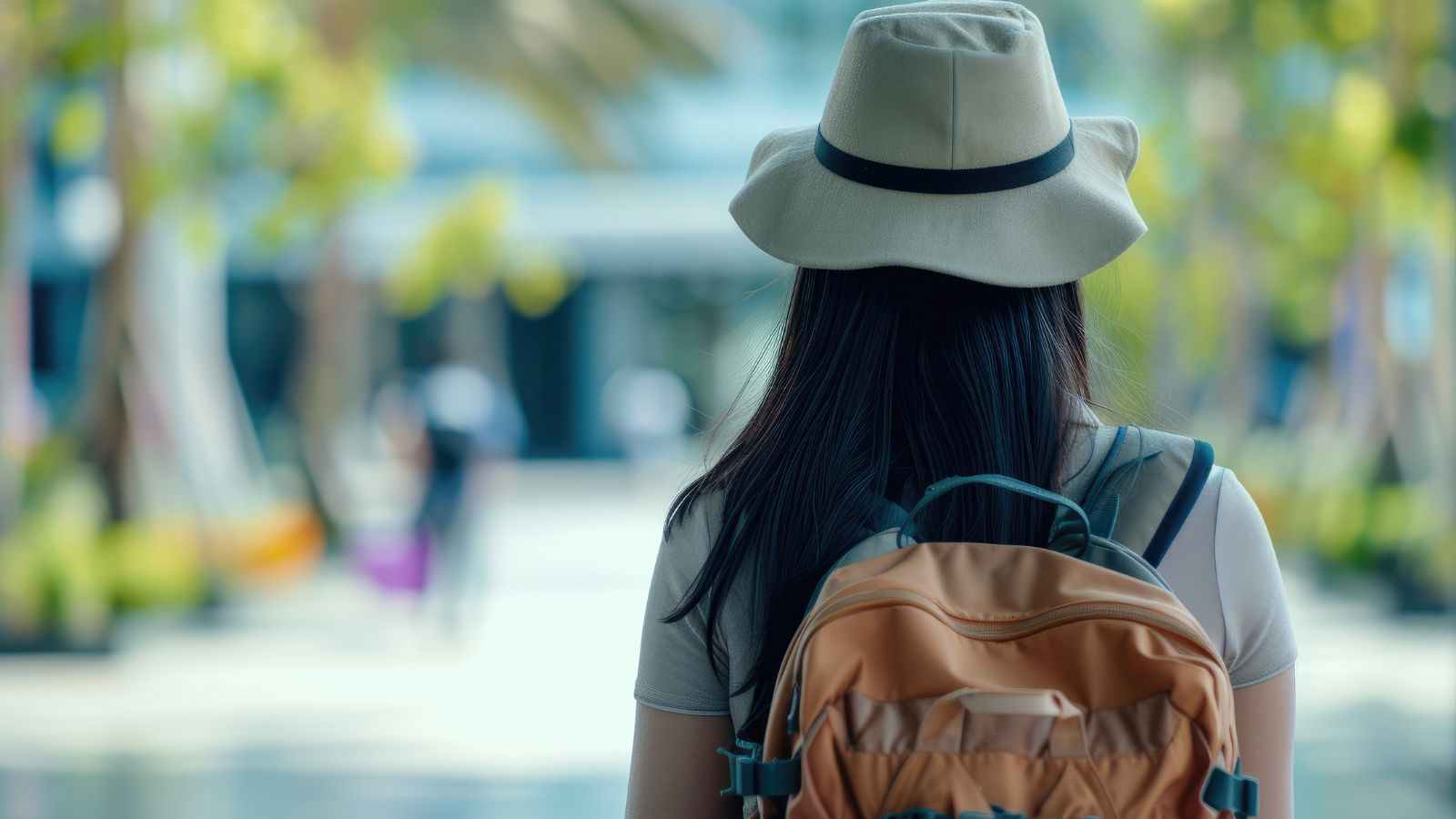 A photo of a woman with a bag heading to enter in a restaurant.