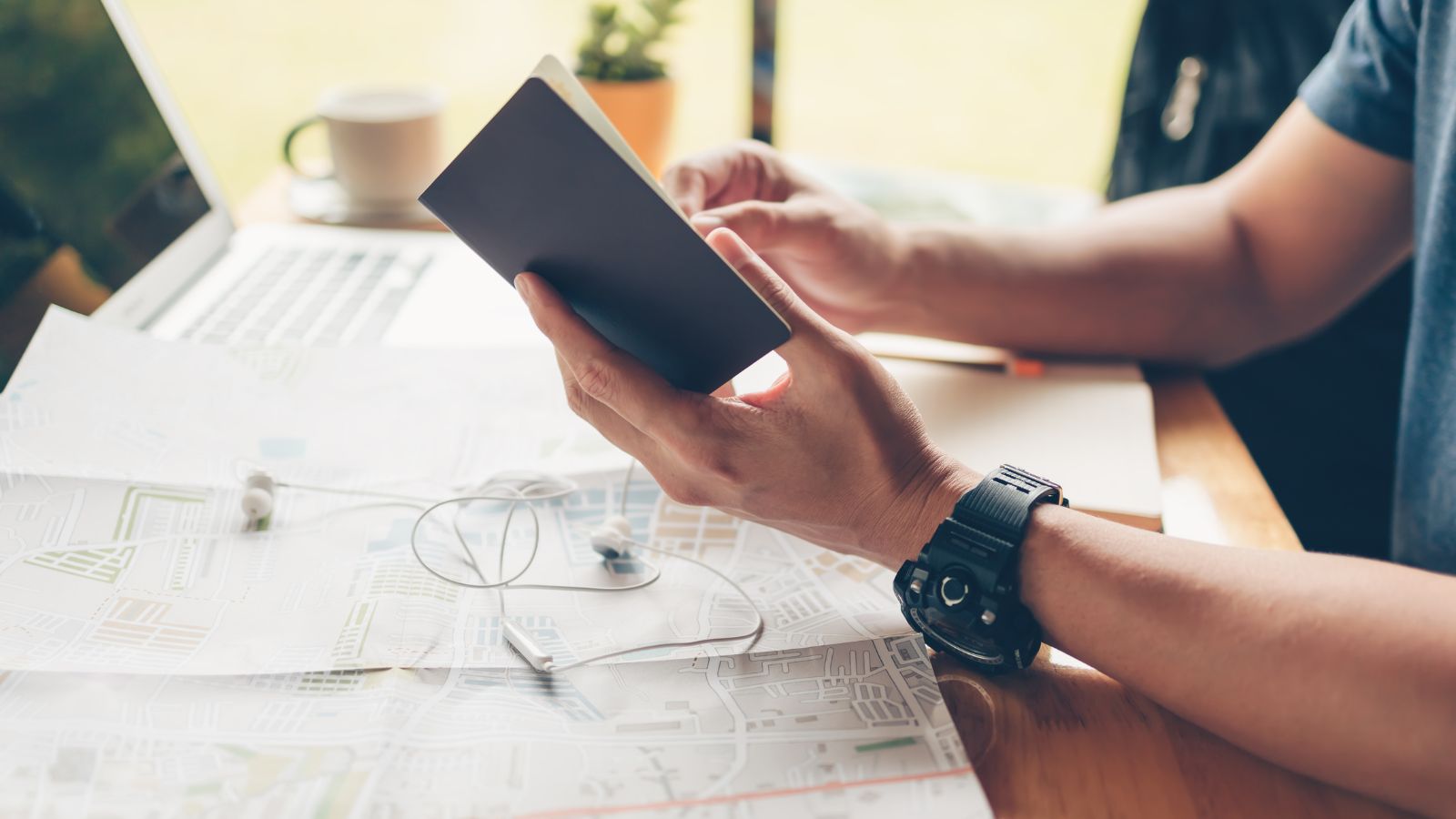 A photo of a man with a passport and a map.