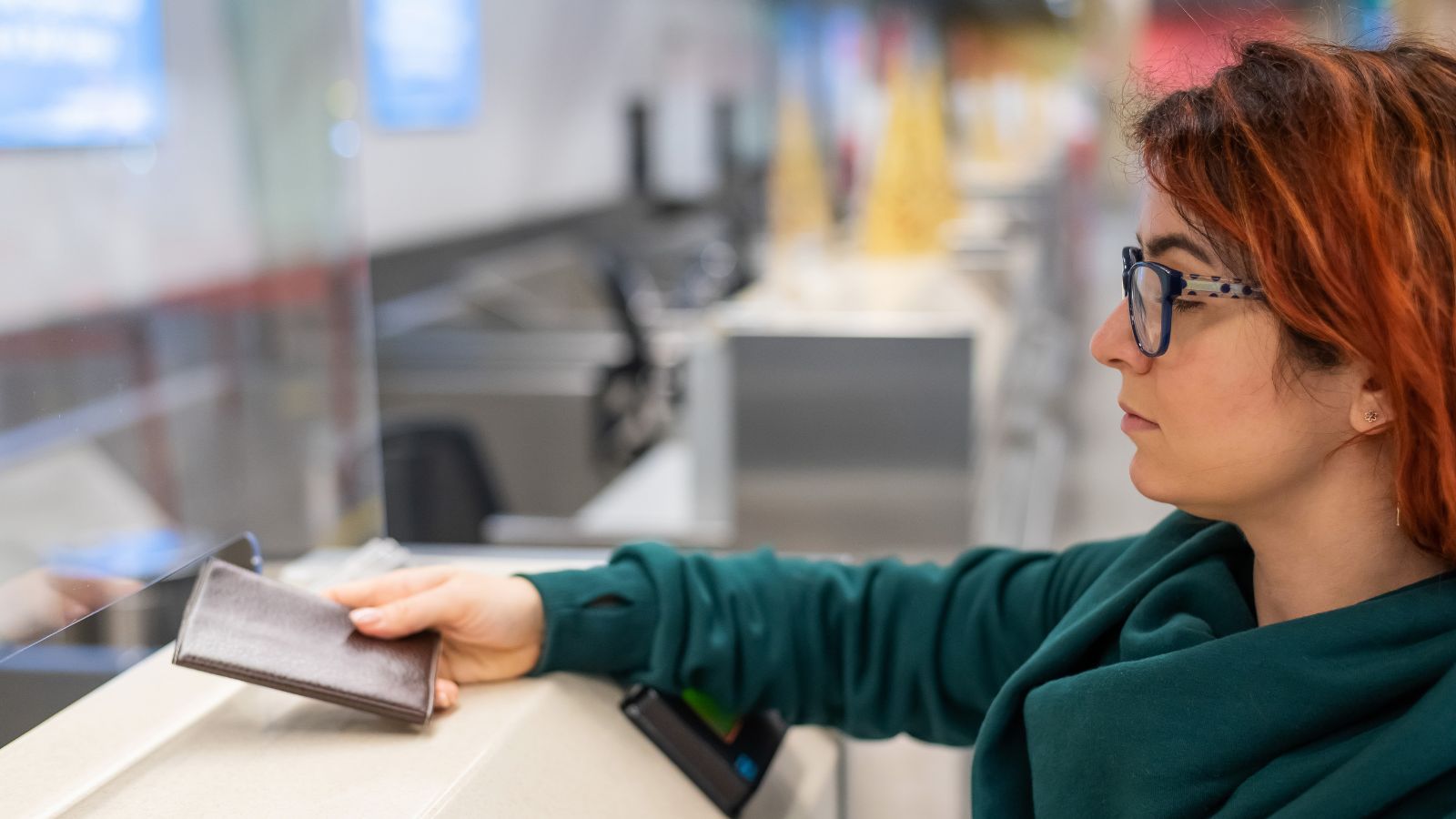 A photo of Traveler at airport immigration area holding passport.