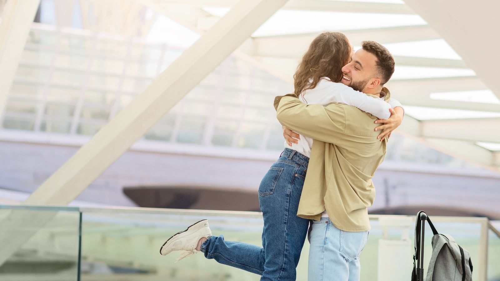 A photo of couple airport departure embrace.