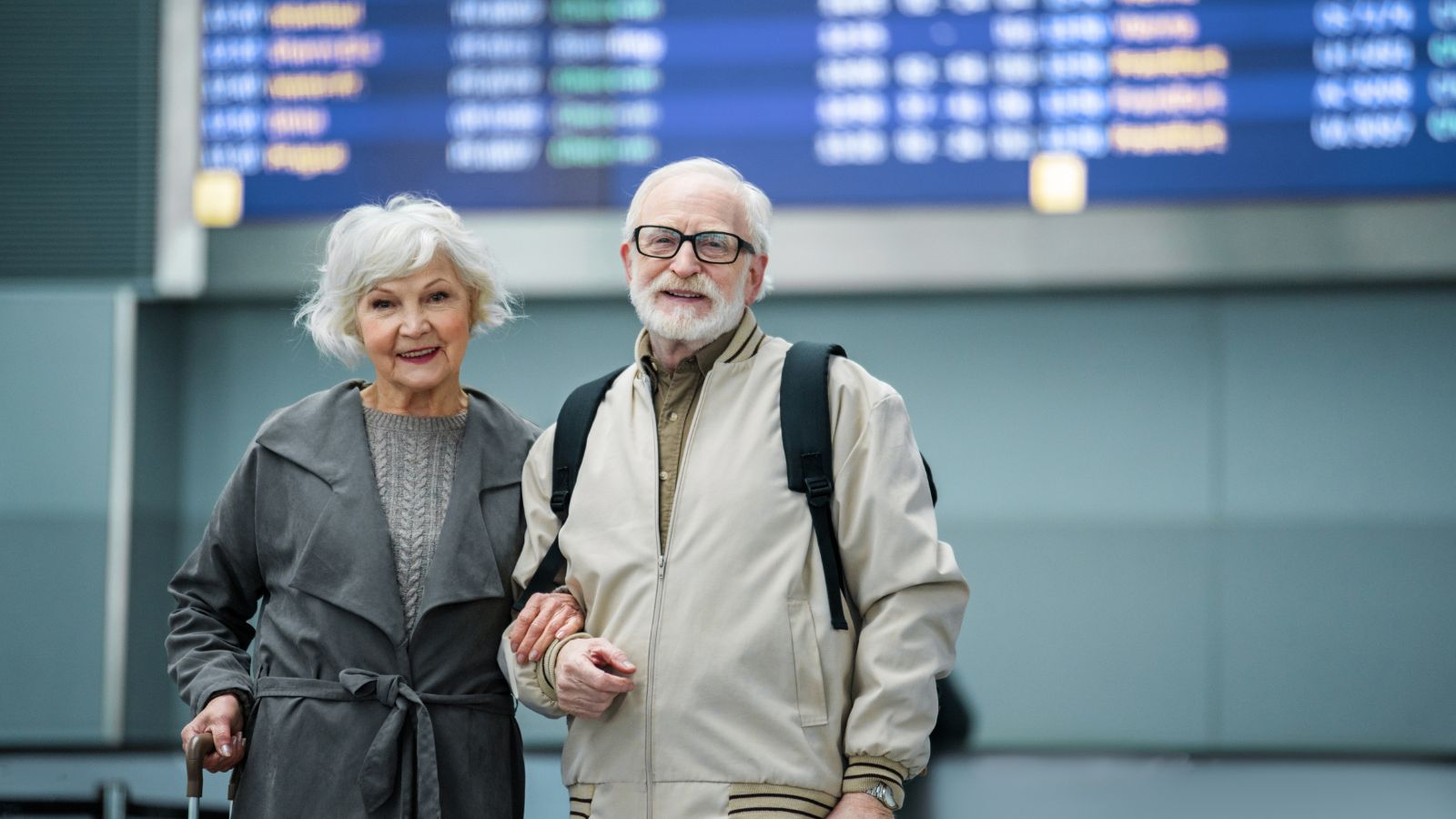 A photo of couple mature couple holding hands boarding airplane calmly.