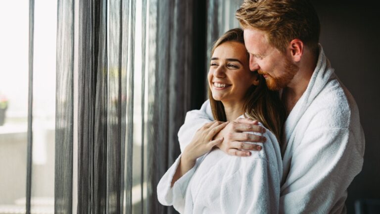 A photo of a couple cuddling in the morning.