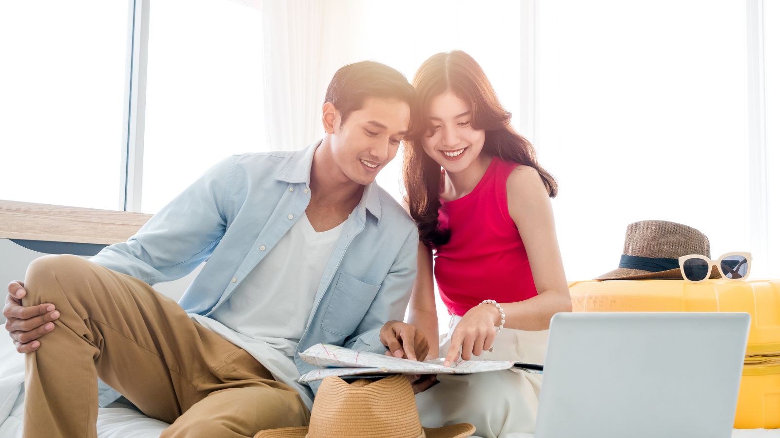 A man and woman examine a book together.