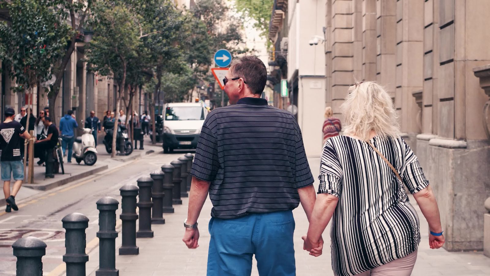 A photo of a couple walking foreign street.