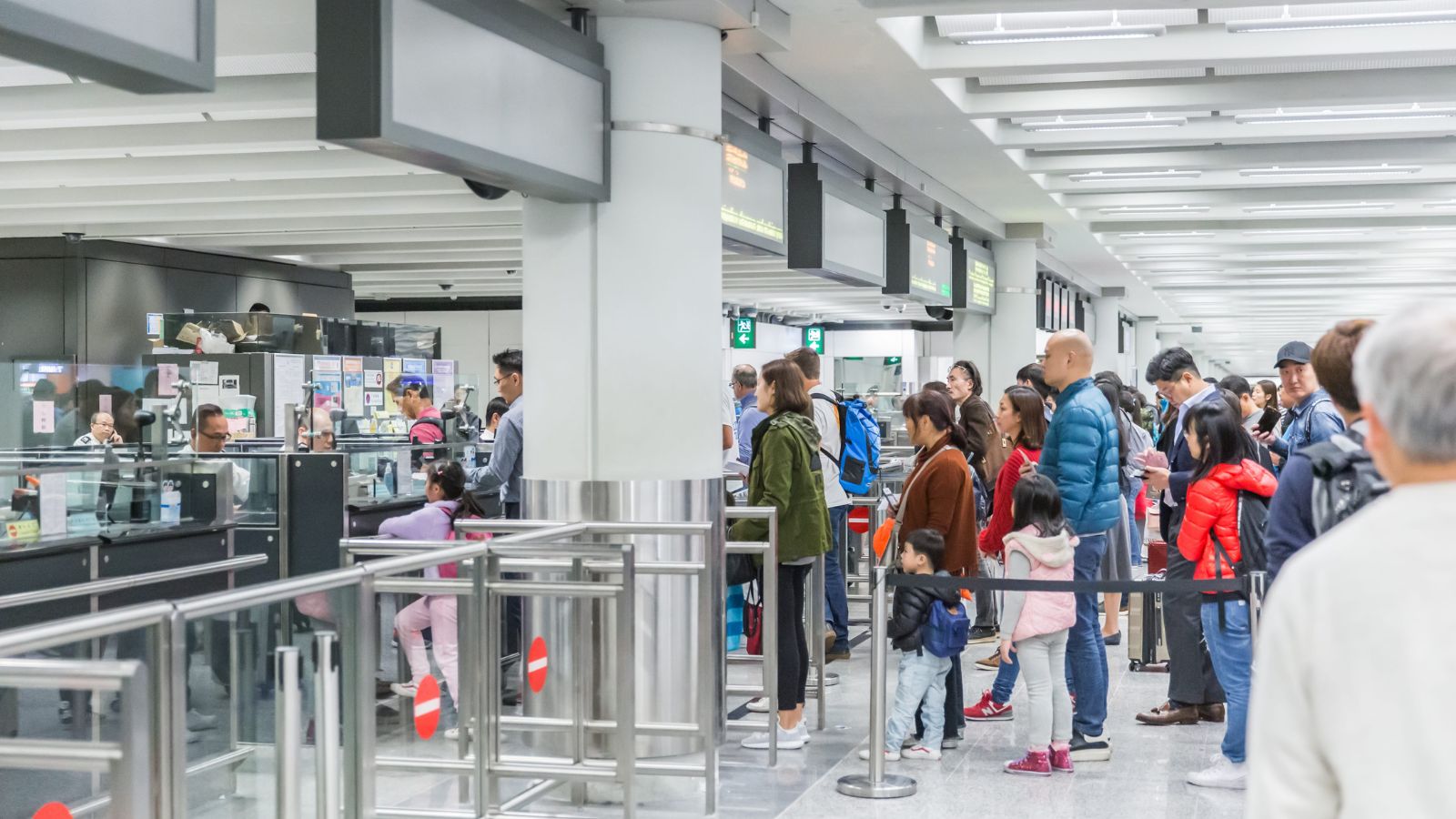 A photo of an overcrowded airport security checkpoint morning.