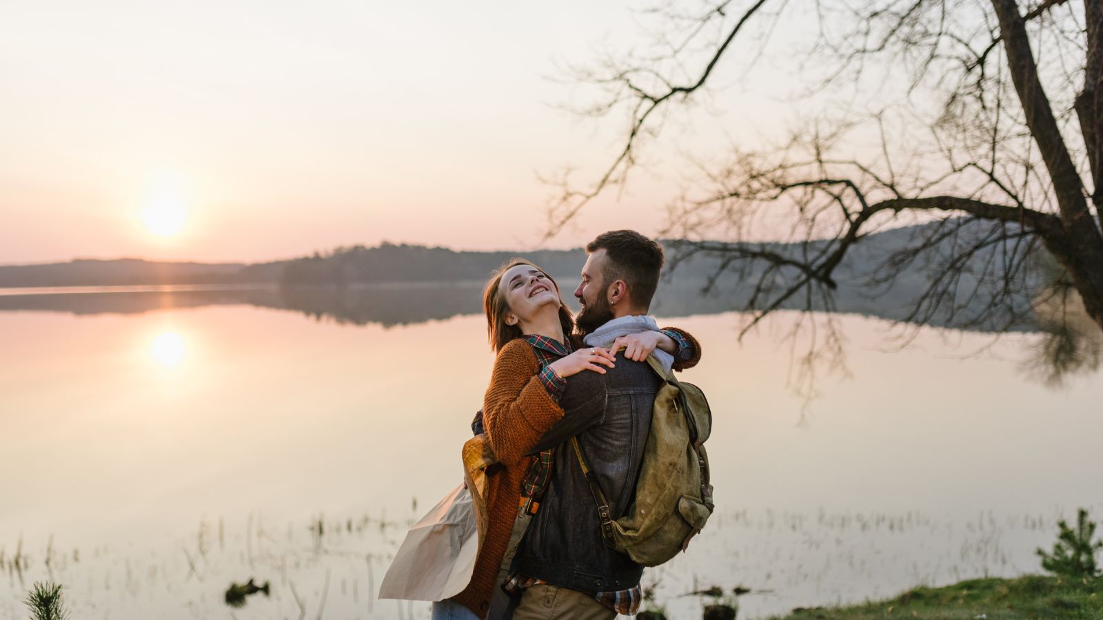 A photo of happy couple sunset embrace.