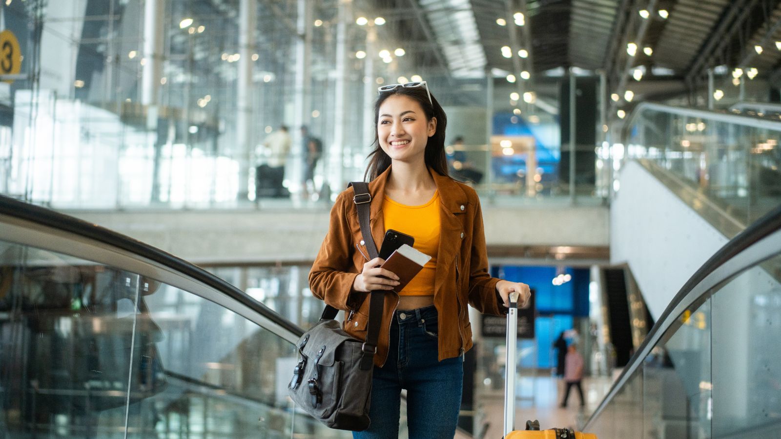 A photo of a calm traveler walking through airport terminal confidently.