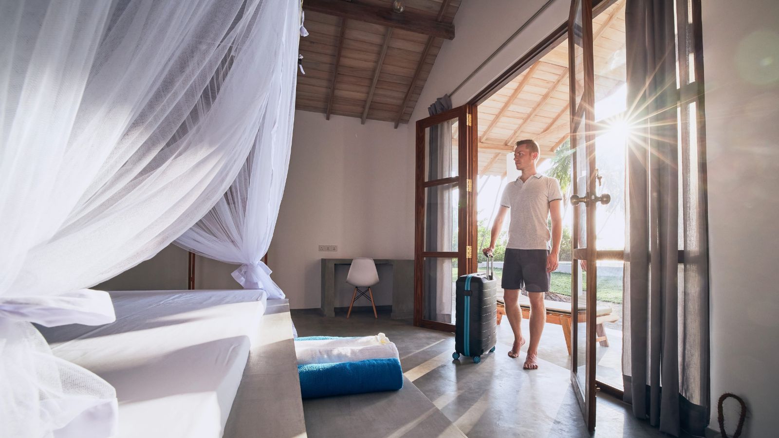 A photo of a hotel room clear walking path natural light.