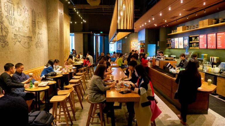 A photo of a restaurant packed with people.